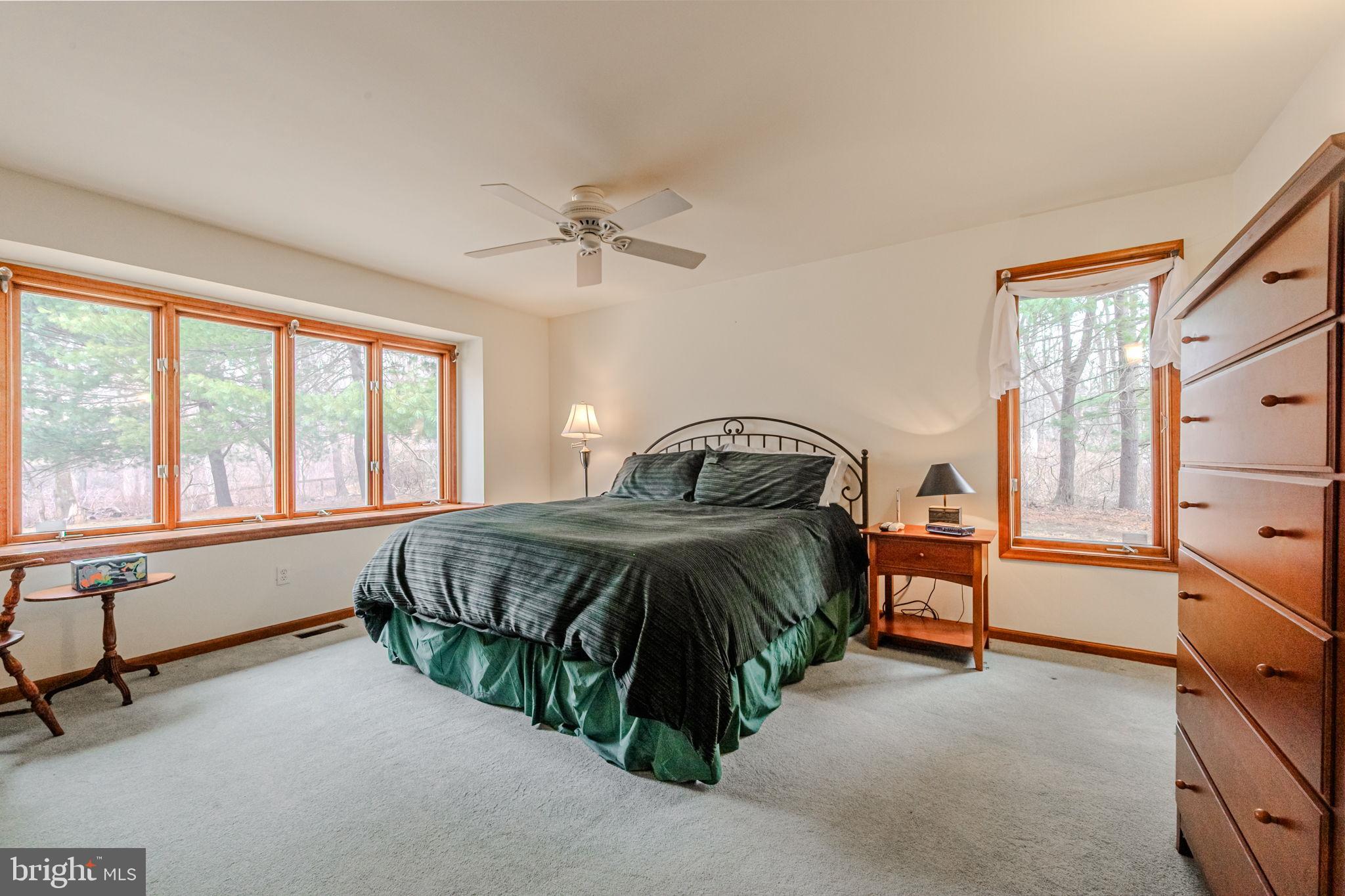53 Bullock Road Chadds Ford, PA 19317 - Photo 36 of 65 a spacious bedroom with a bed and a table chair
