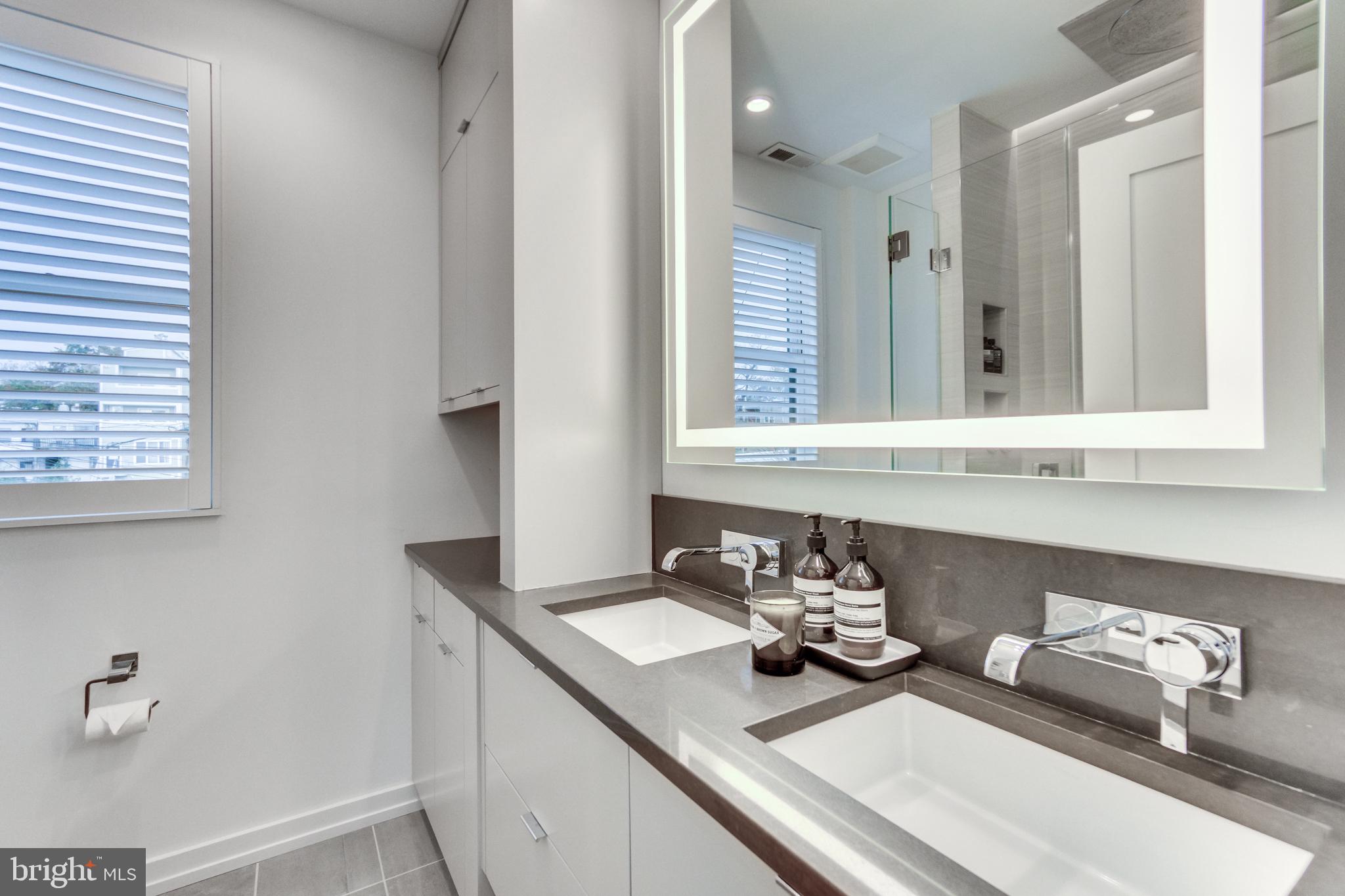 1009 Irving Street Northwest Washington, DC 20010 - Photo 25 of 33 Sleek modern bathroom with natural light.