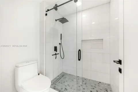 a bathroom with a toilet and a shower