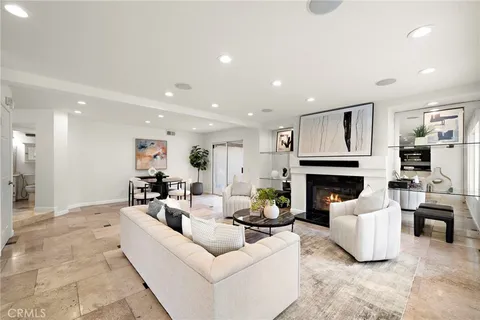 a kitchen with stainless steel appliances kitchen island granite countertop a refrigerator a stove a sink dishwasher with a dining table and chairs with wooden floor