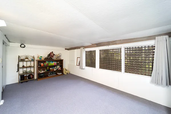 a view of a livingroom with toys and a large window