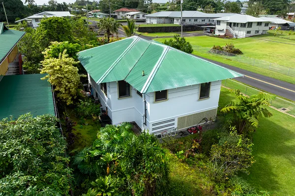 an aerial view of a house with swimming pool garden and lake view