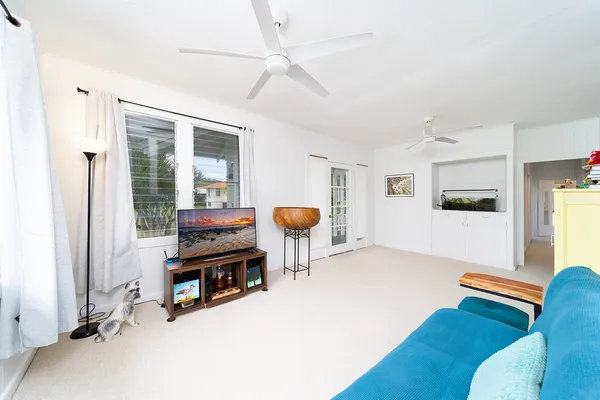 a living room with furniture a dining table and chairs with wooden floor