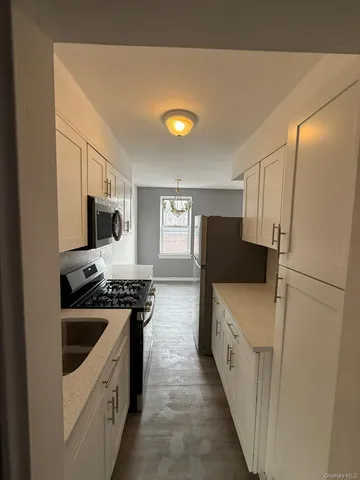 a kitchen with a sink a stove and refrigerator