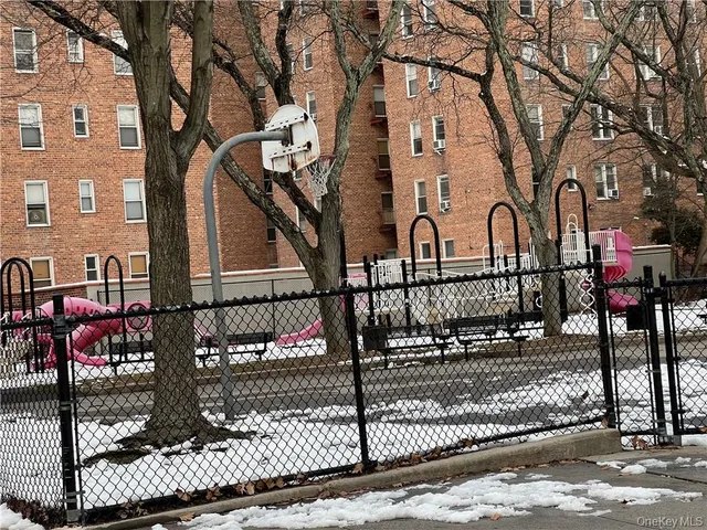 a view of a brick house with iron fence