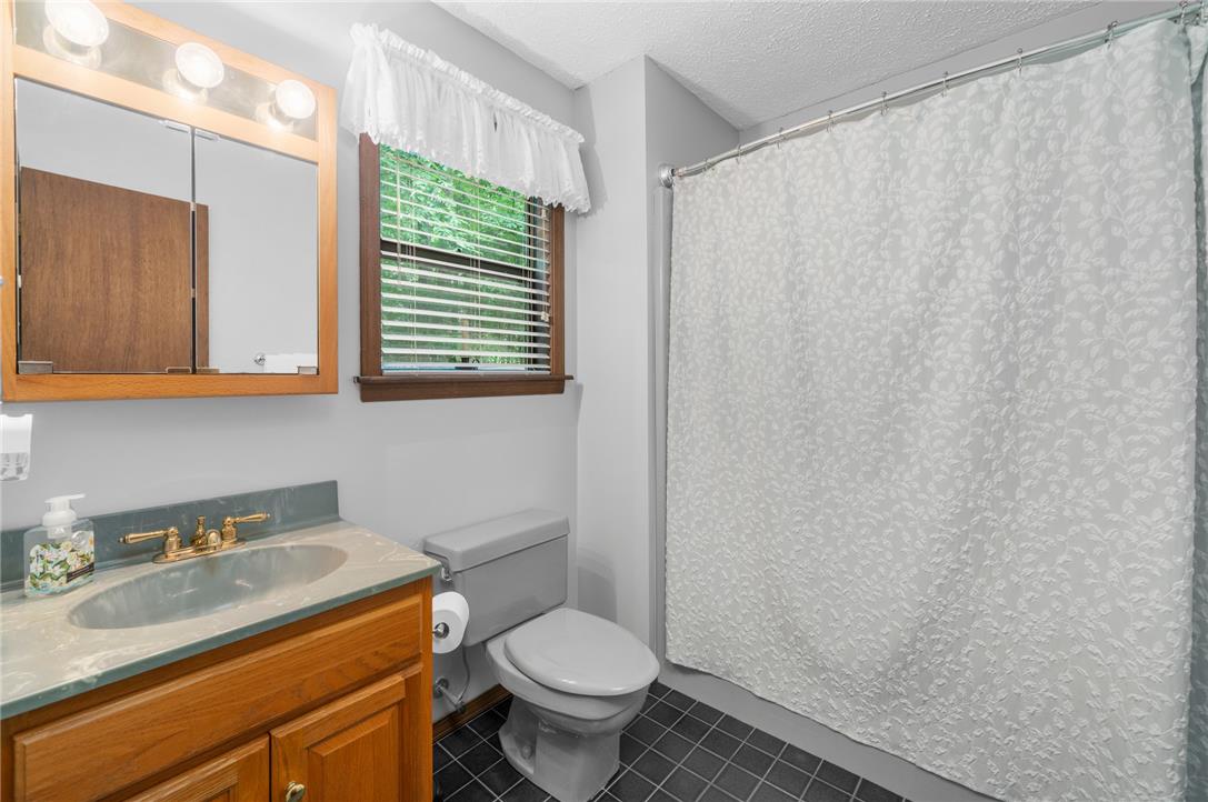 222 Powder Horn Road Henryville, PA 18332 - Photo 16 of 25 A well-appointed bathroom offers a practical vanity and a classic shower-over-tub setup.