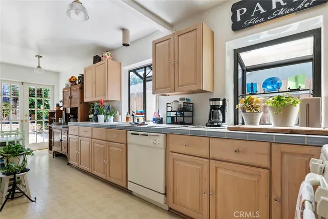 a kitchen with cabinets a sink and a window