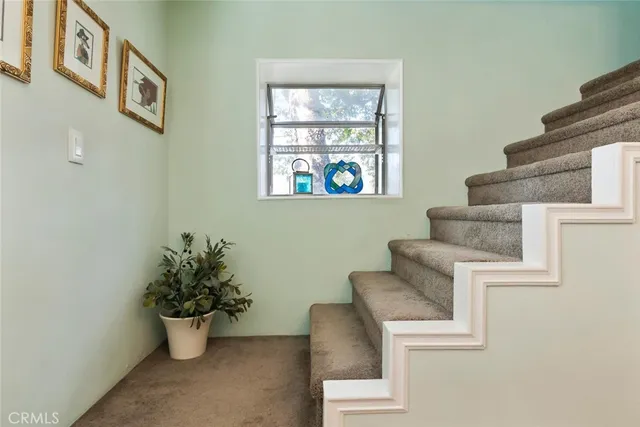 a white couch sitting in a living room next to a window