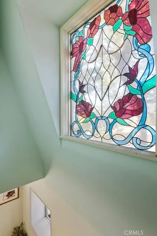 a bedroom with a bed dresser and window