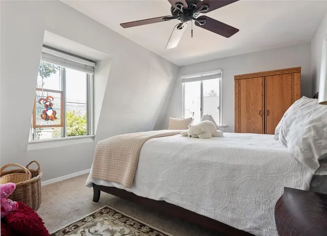 a bedroom with a bed and window