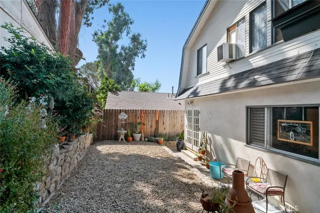 a backyard of a house with outdoor seating