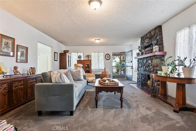 a living room with furniture a fireplace and a flat screen tv