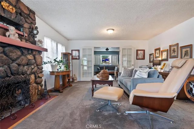 a living room with furniture a fireplace and a bookshelf
