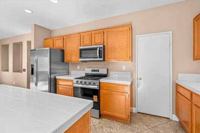 a kitchen with stainless steel appliances a refrigerator stove and sink