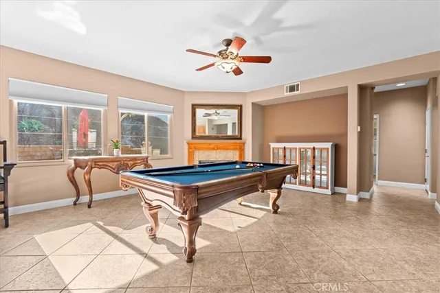 a living room with patio furniture and a dining table