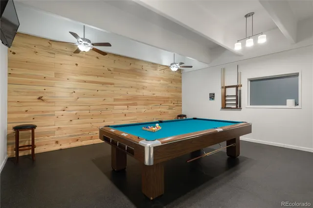 a room with pool table and a chandelier