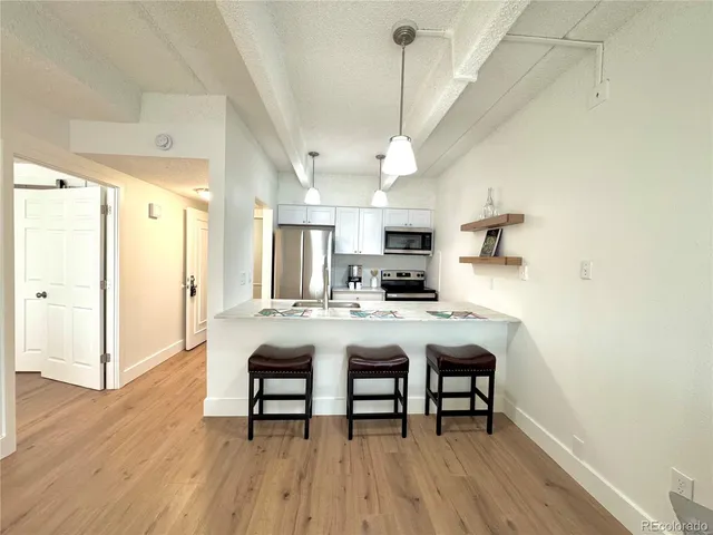 a large kitchen with a table and chairs