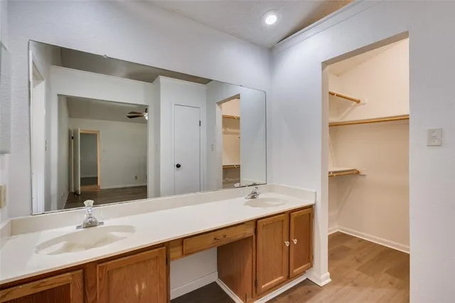 a bathroom with a double vanity sink mirror and