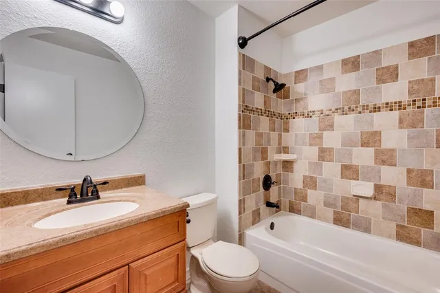 a bathroom with a sink toilet a mirror and shower