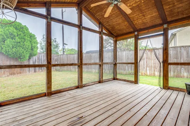 a view of a room with wooden floor and windows