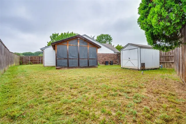 a view of a house with a yard and garage