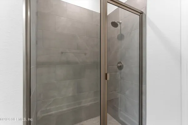 a bathroom with a glass shower door
