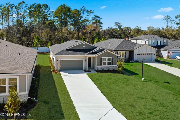 a front view of house with yard and green space