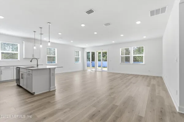 a view of kitchen and hall with wooden floor