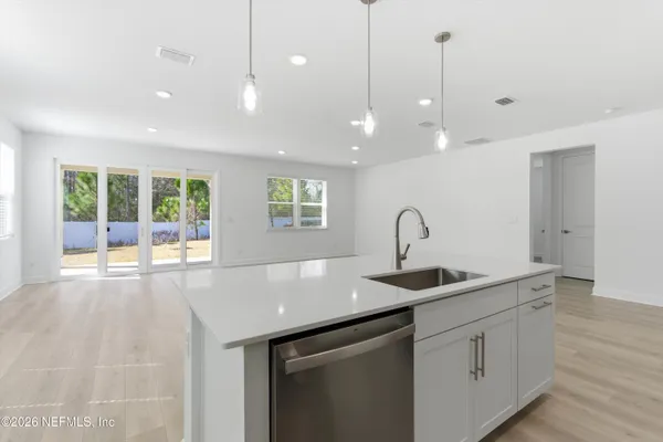 a kitchen with kitchen island a sink and a large window