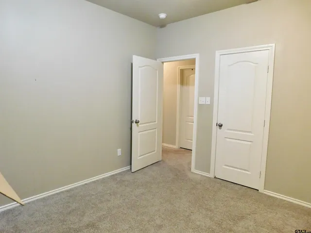 an empty room with closet area
