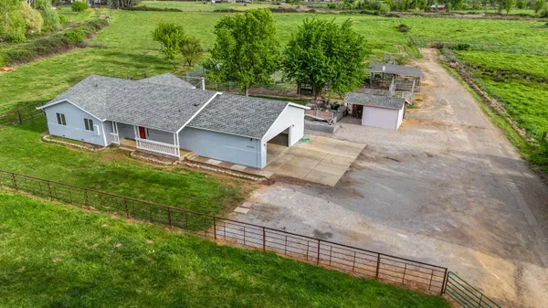 an aerial view of a house with porch yard basket ball court and outdoor seating