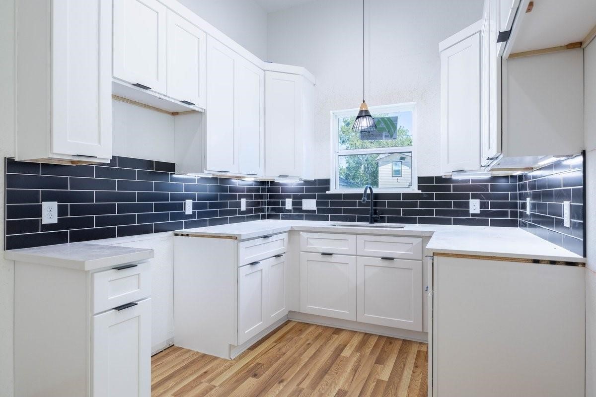 408 Armstrong Street, Unit B Houston, TX 77029 - Photo 8 of 14 a kitchen with a sink stove and cabinets