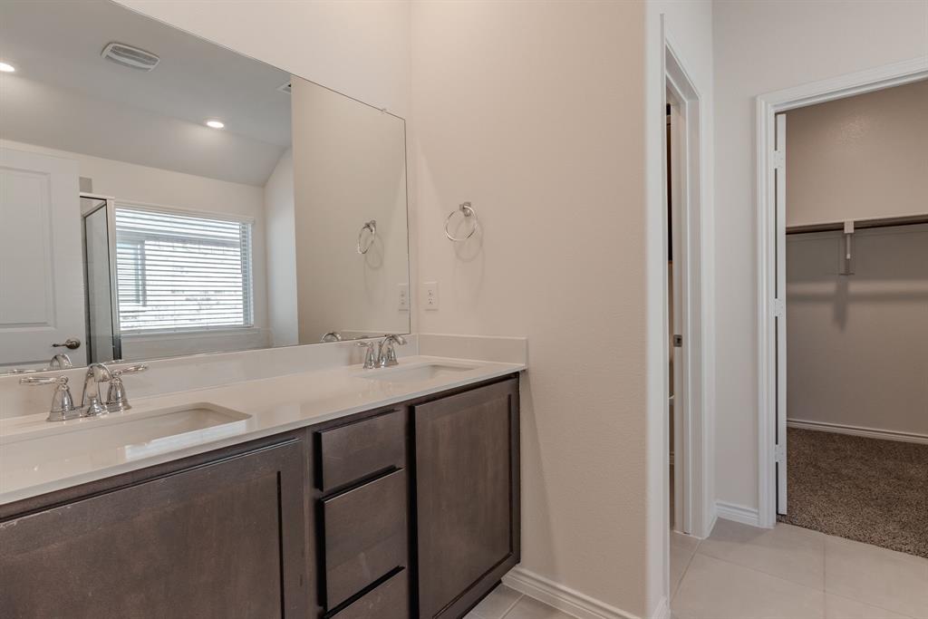 2902 Trusting Way Aubrey, TX 76227 - Photo 28 of 38 Double vanity with undermount sinks, chrome fixtures, and a white countertop