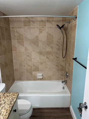 a bathroom with a toilet bathtub and shower