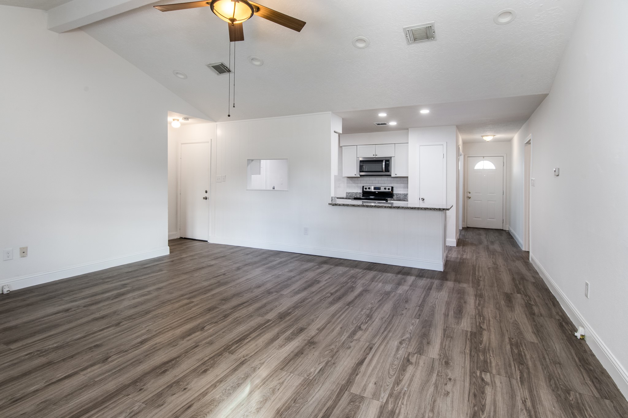 9707 Whitepost Lane Houston, TX 77086 - Photo 11 of 30 a view of a kitchen with a sink and wooden floor