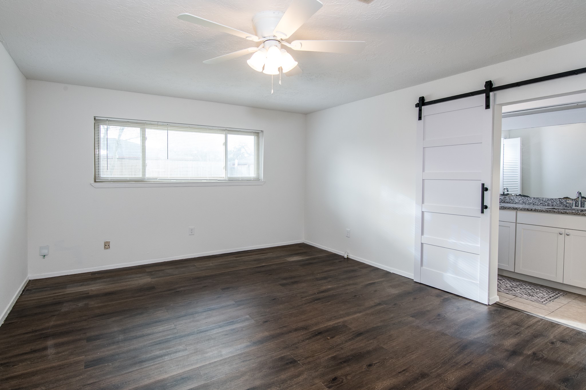 9707 Whitepost Lane Houston, TX 77086 - Photo 12 of 30 wooden floor in an empty room with a window