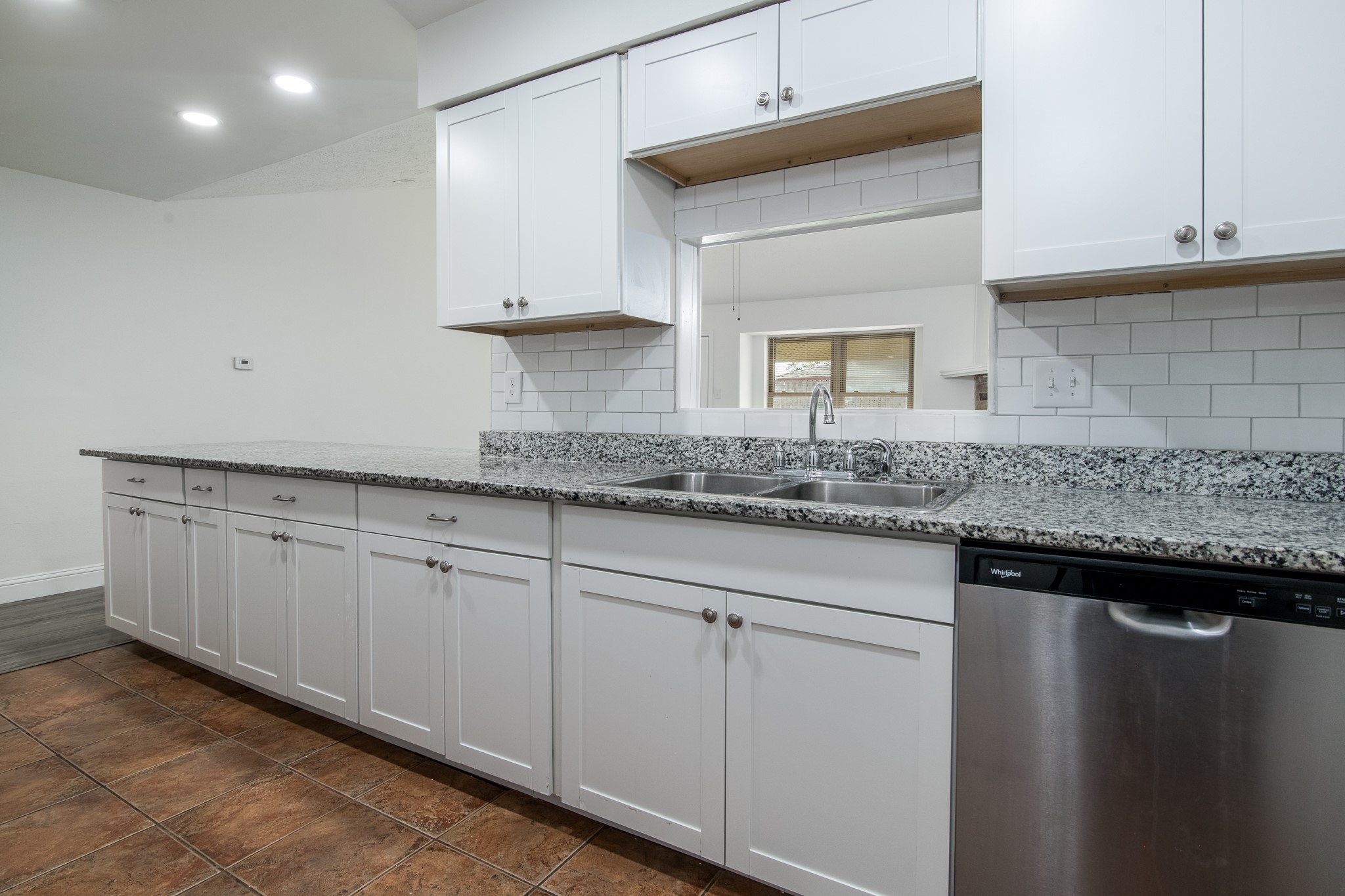 9707 Whitepost Lane Houston, TX 77086 - Photo 2 of 30 a kitchen with granite countertop white cabinets and a sink