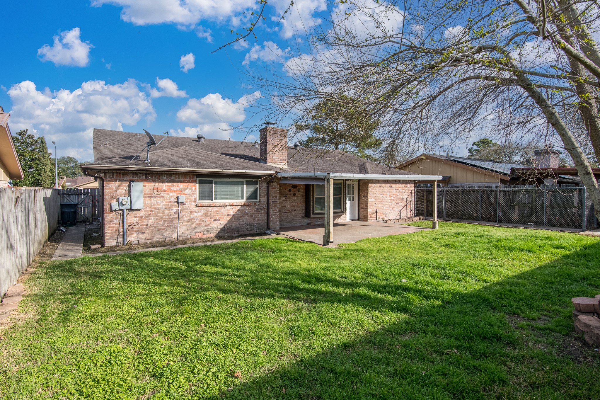 9707 Whitepost Lane Houston, TX 77086 - Photo 21 of 30 a view of a house with a yard and a tree