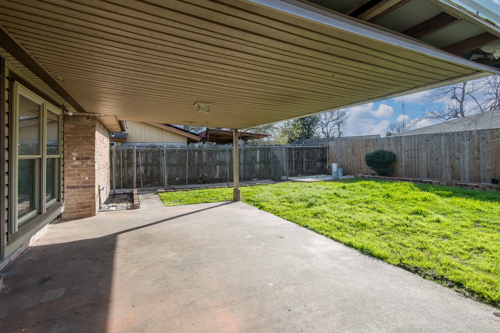 9707 Whitepost Lane Houston, TX 77086 - Photo 22 of 30 a view of a backyard with table and chairs under an umbrella