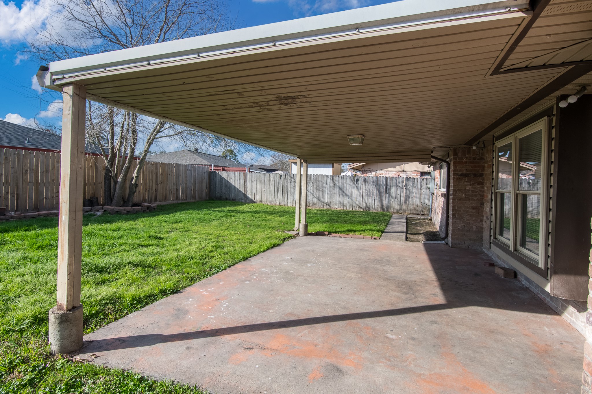 9707 Whitepost Lane Houston, TX 77086 - Photo 23 of 30 a view of a patio with a table and chairs under an umbrella