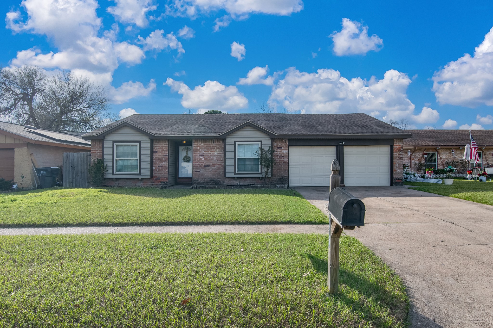 9707 Whitepost Lane Houston, TX 77086 - Photo 24 of 30 a front view of a house with a garden and yard