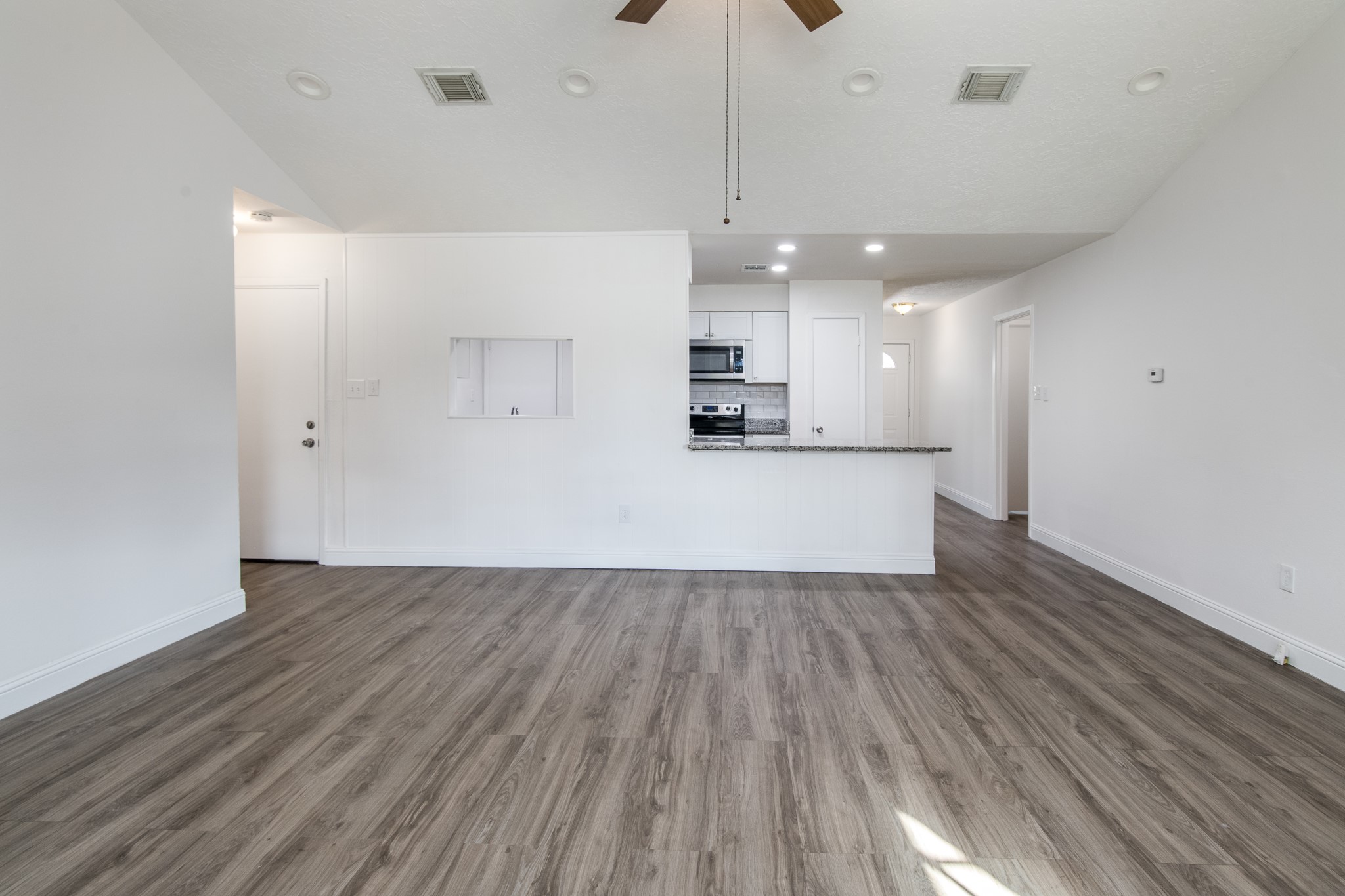 9707 Whitepost Lane Houston, TX 77086 - Photo 6 of 30 a view of a kitchen with a sink and wooden floor