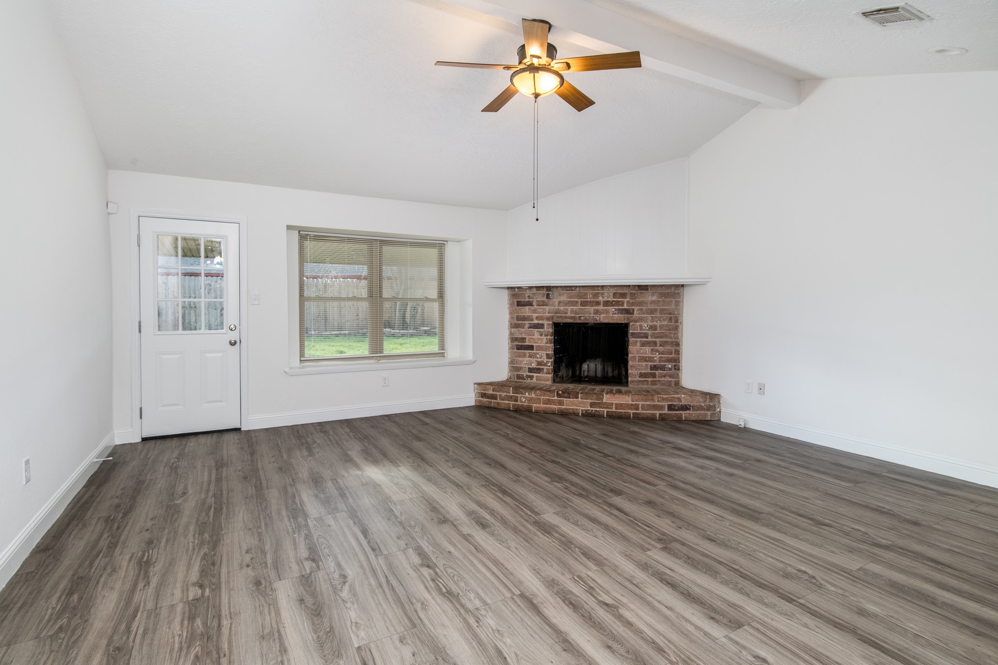 9707 Whitepost Lane Houston, TX 77086 - Photo 7 of 30 an empty room with windows and fireplace