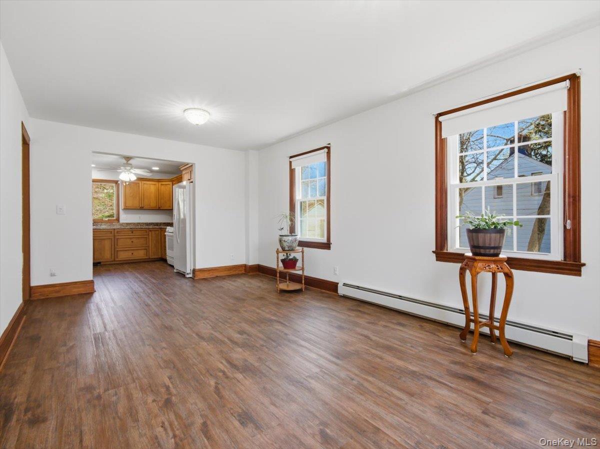 311 Gate Hill Coop Road Stony Point, NY 10980 - Photo 11 of 42 Dining area with wood-style flooring, white walls, and wood trim around windows and doorways