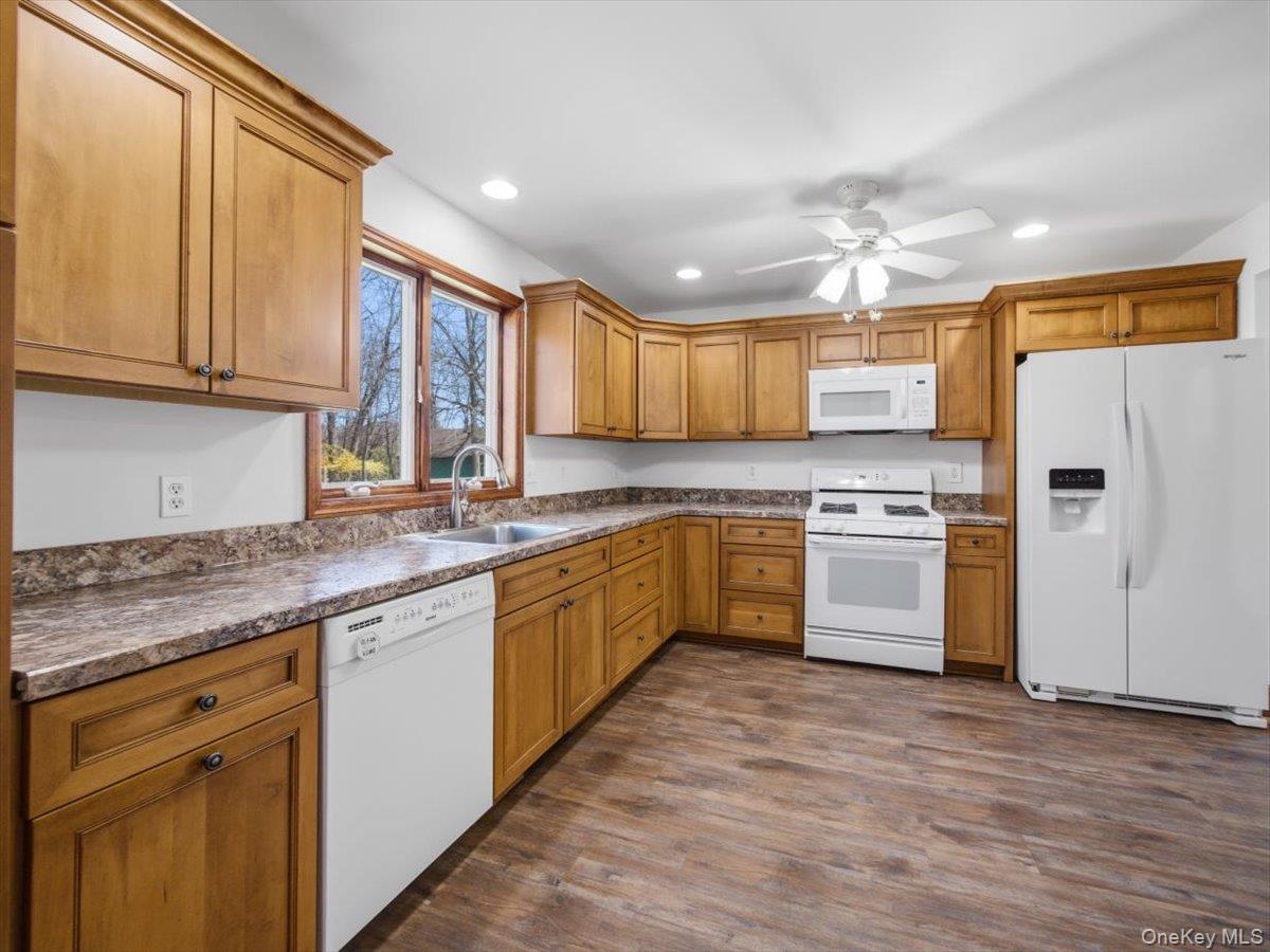311 Gate Hill Coop Road Stony Point, NY 10980 - Photo 16 of 42 The kitchen features wood cabinetry, mottled countertops, and white appliances including a refrigerator, dishwasher, and stove