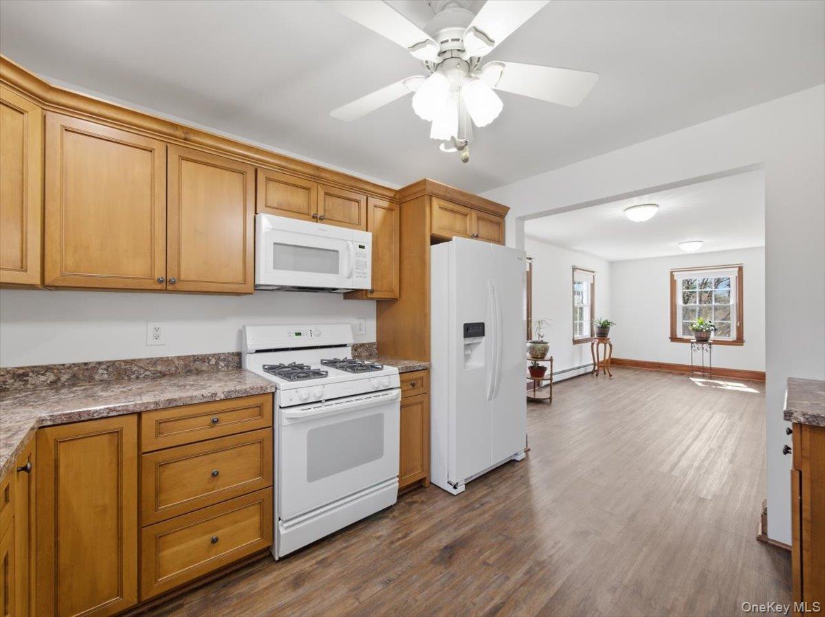 311 Gate Hill Coop Road Stony Point, NY 10980 - Photo 17 of 42 The kitchen features wood cabinetry, white appliances, and a ceiling fan