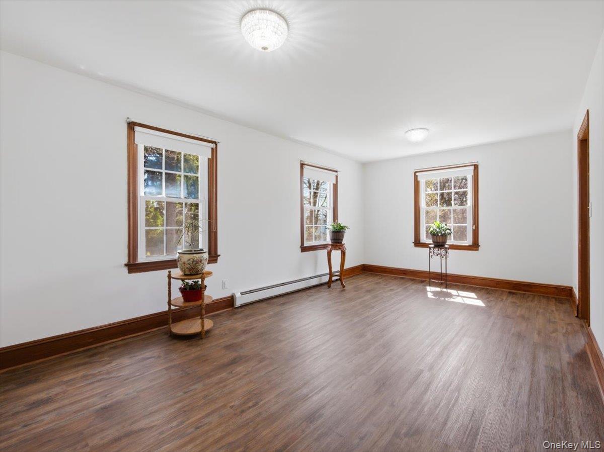 311 Gate Hill Coop Road Stony Point, NY 10980 - Photo 18 of 42 This room features light wood flooring, white walls, and warm wood trim around the windows and baseboards
