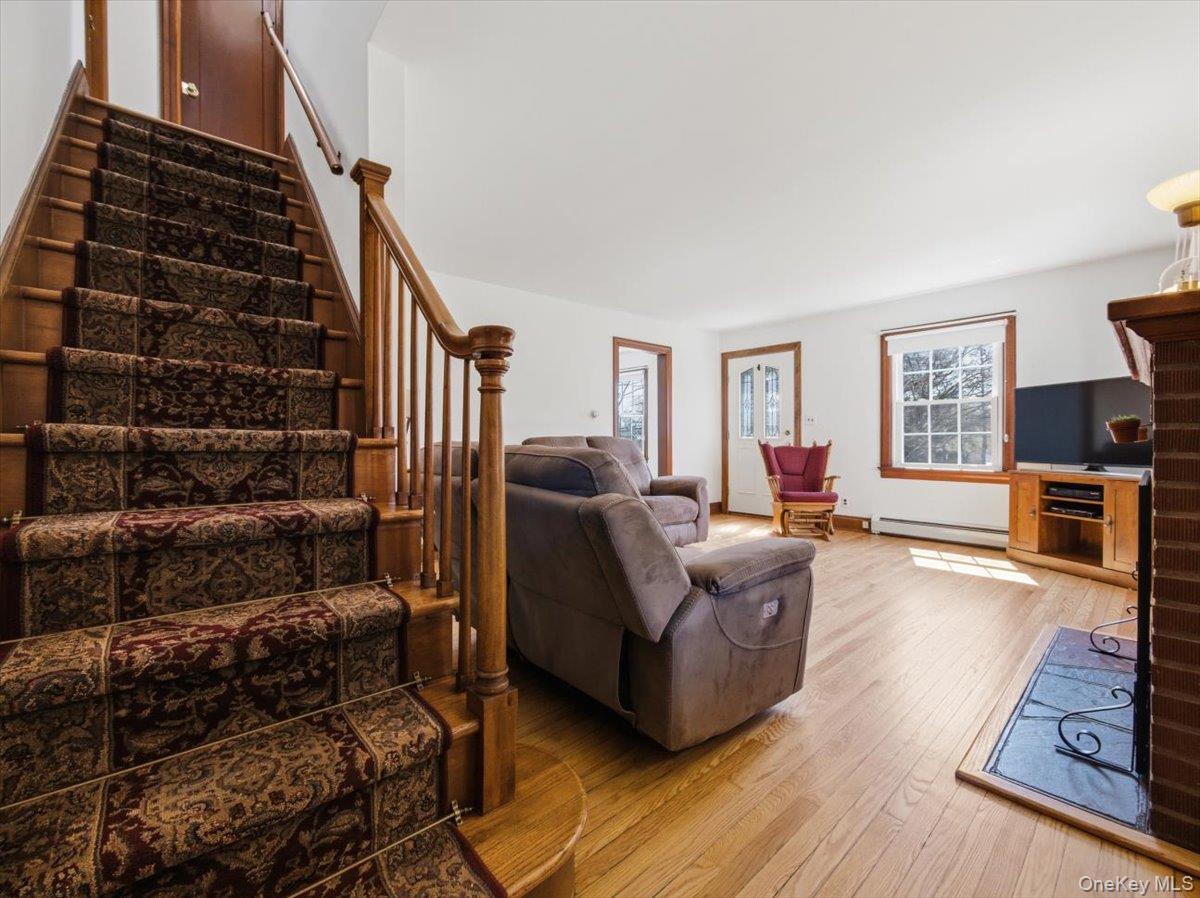 311 Gate Hill Coop Road Stony Point, NY 10980 - Photo 21 of 42 featuring a wooden staircase with patterned carpet runner, leading to a wooden banister