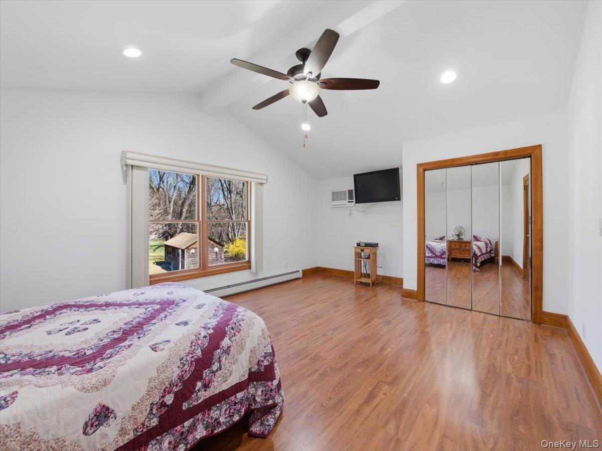 311 Gate Hill Coop Road Stony Point, NY 10980 - Photo 22 of 42 This room features vaulted ceilings with recessed lighting and a ceiling fan, wood flooring, and a window providing views of the outdoors