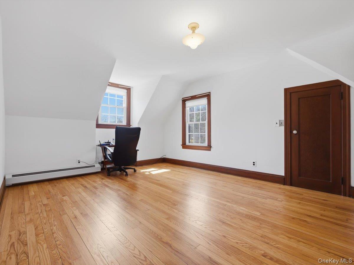 311 Gate Hill Coop Road Stony Point, NY 10980 - Photo 27 of 42 Bright room featuring hardwood floors, white walls, and two windows providing natural light